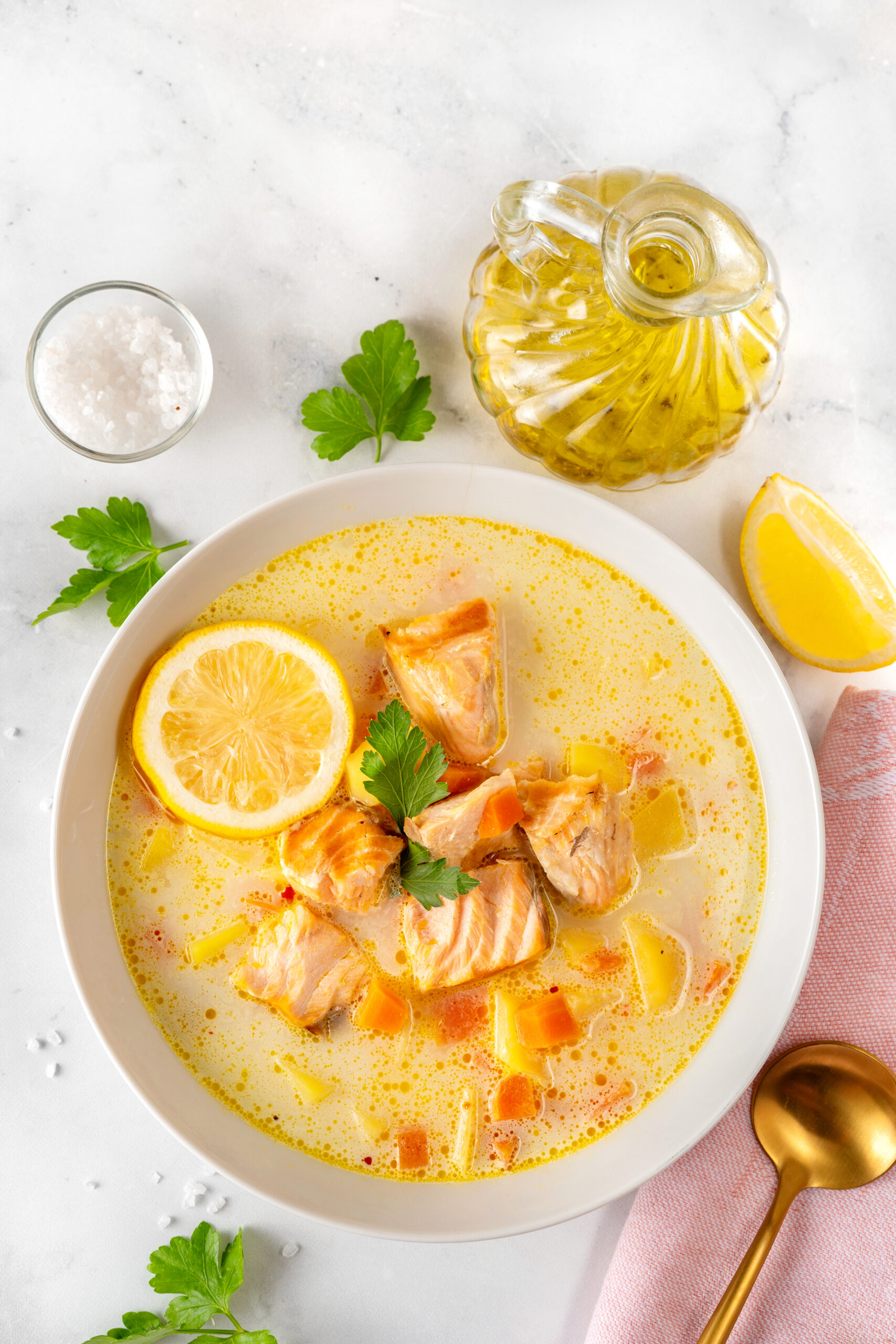 Close up of salmon cream soup plate on white background. Top view. Healthy food concept