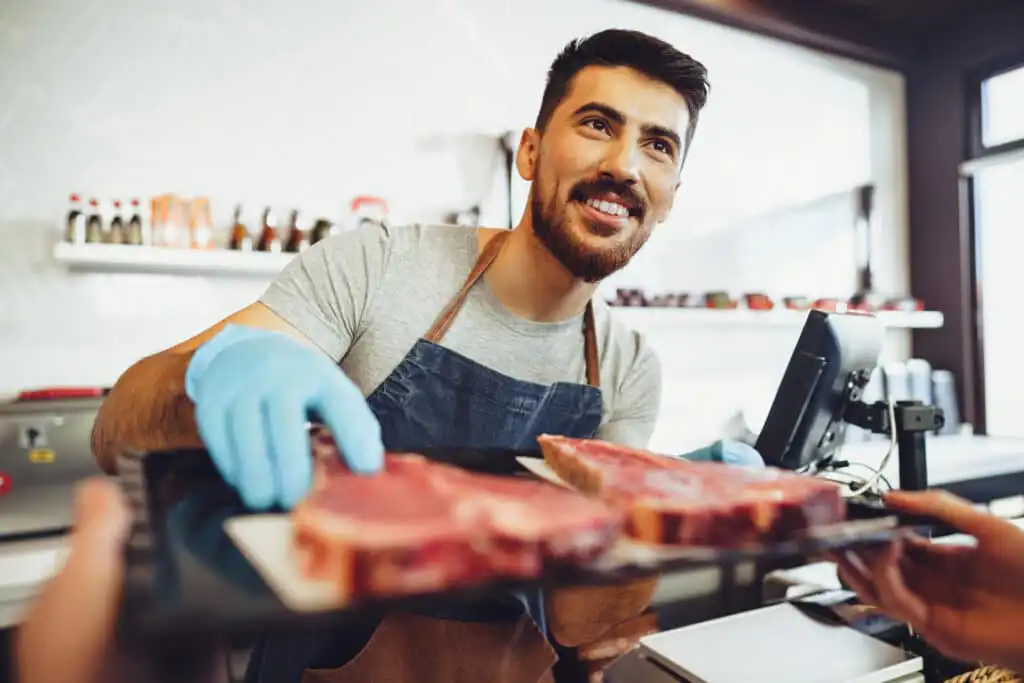 butcher 39 s shop seller helps to choose product 2023 11 27 04 52 22 utc 1
